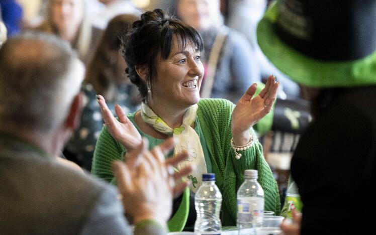 A lady all dressed in green, enjoying St Patrick's Day celebrations