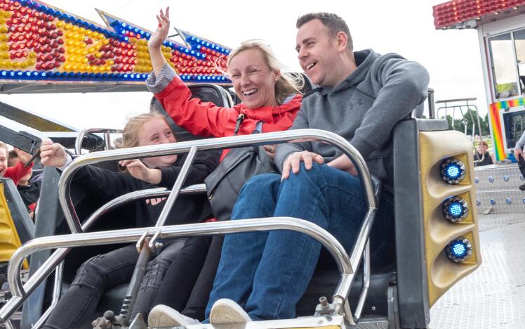 A family enjoying a fun fair ride at Doncaster Races.